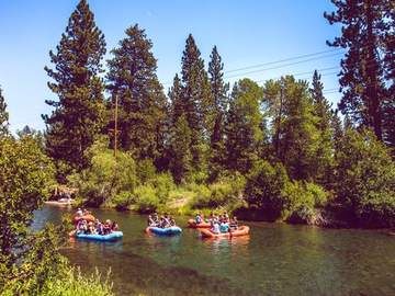 Rafts drifting on the clear green water of the Truckee River