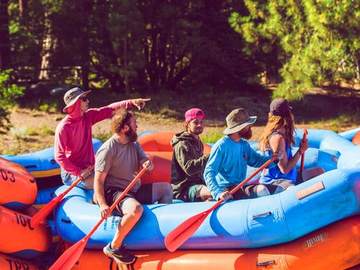 A raft of guests paddling in the sun on the Truckee River