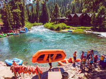 Staff and guests grouped at the Truckee River Raft Co. check-in area
