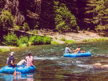 Rafters paddling the Truckee River on a summer afternoon