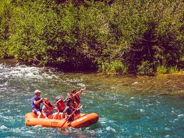Guests with paddles raised on the Truckee River