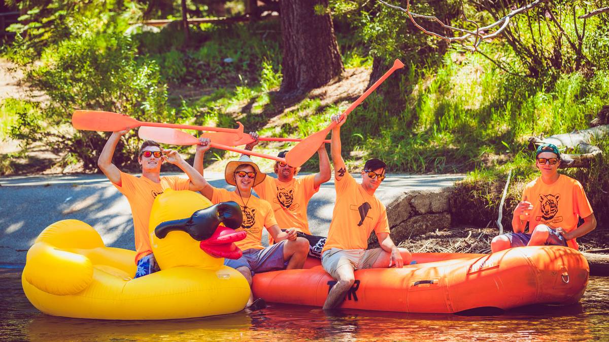 Rafts and guests gathered at the Truckee River Raft Company launch area beside the river in Tahoe City